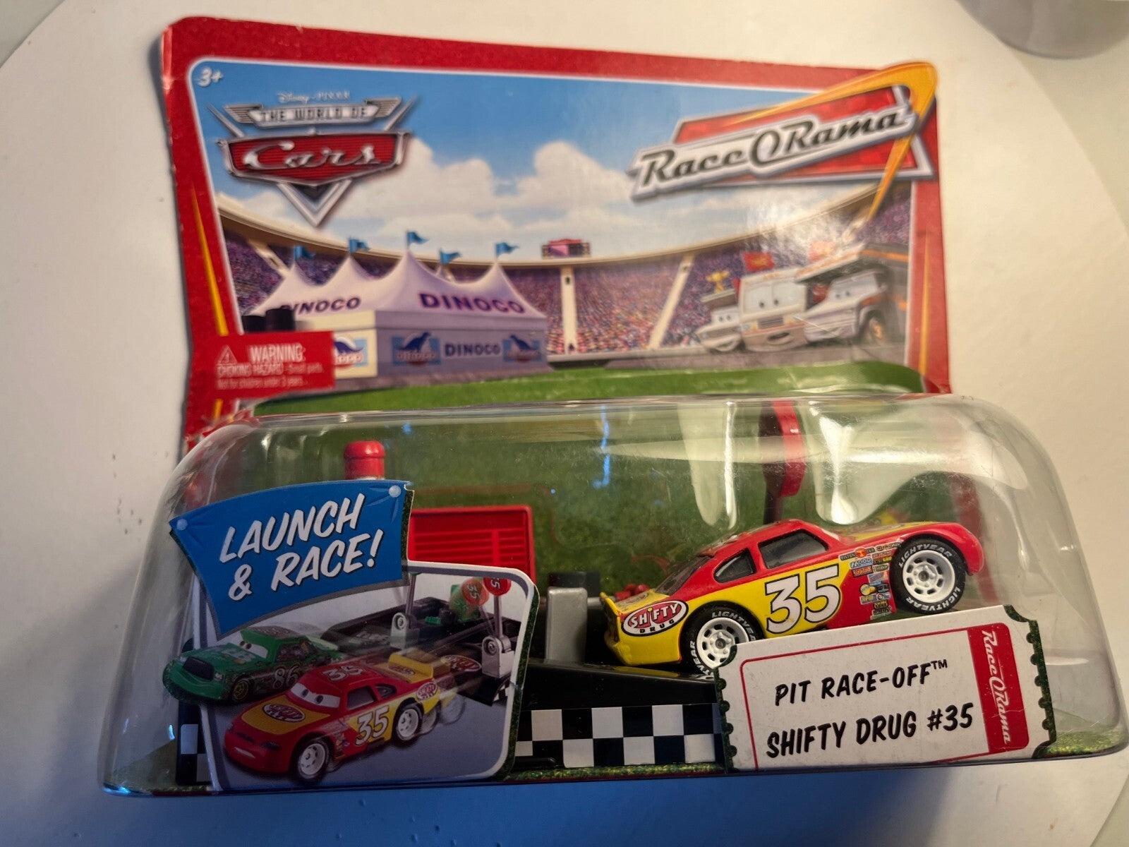 Voiture Cars Disney Kevin Racingtire + lanceur blister abimé mais voiture neuve