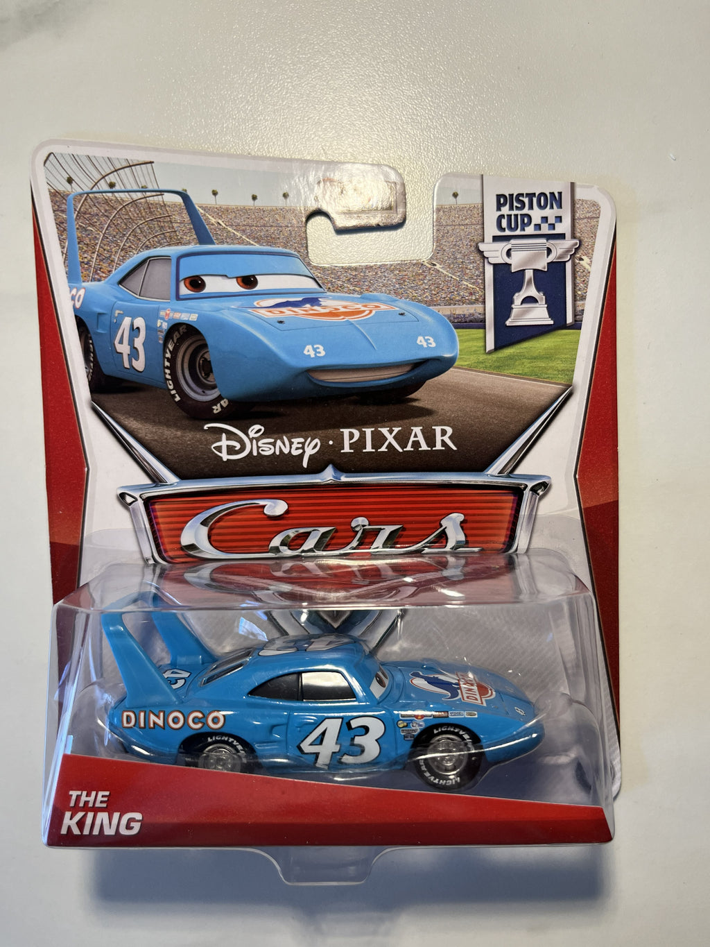 The King Dinoco #43 – Disney Pixar Cars – Piston Cup Series (2012) – Neuf sous blister