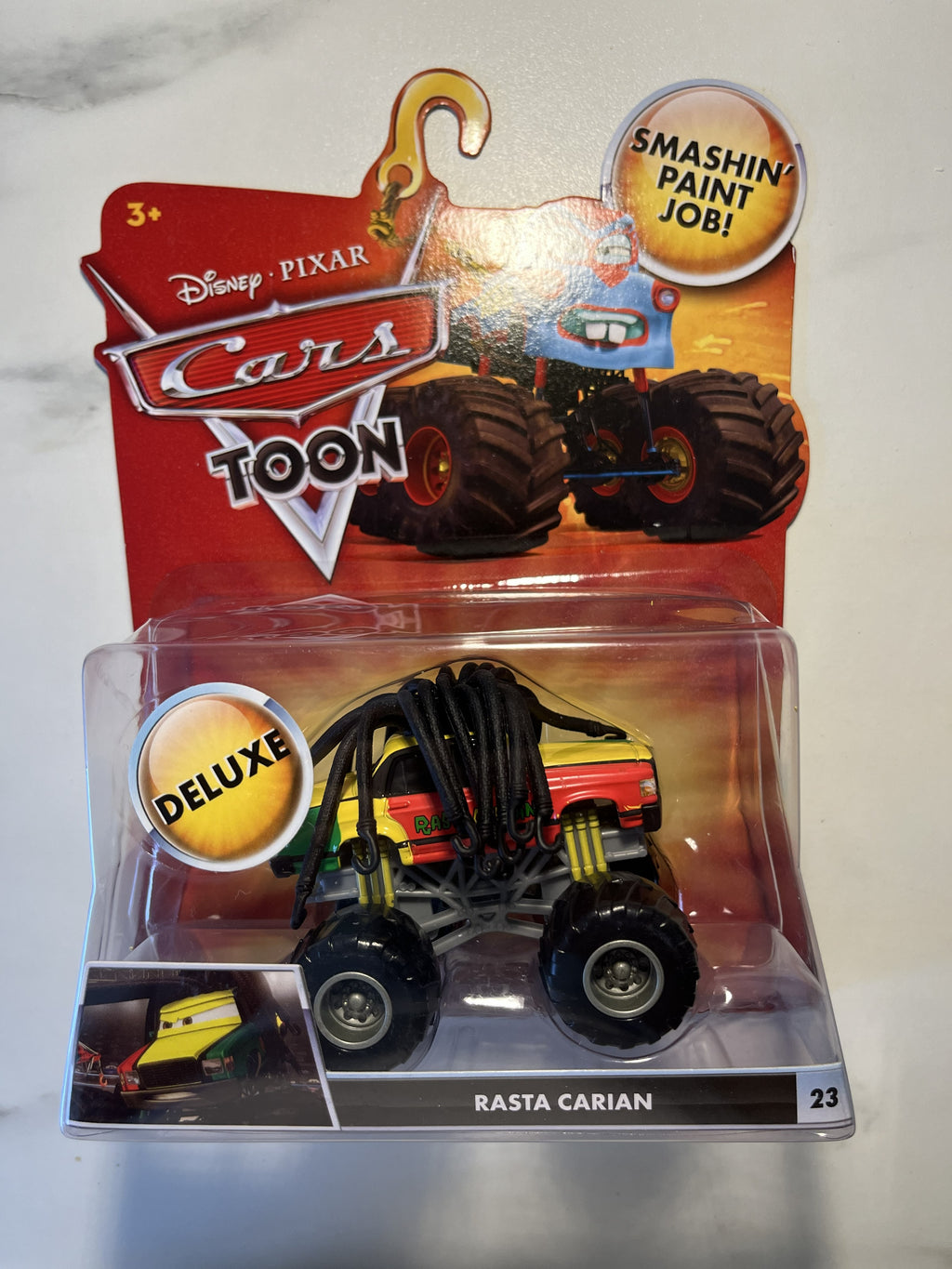Rasta Carian #23 – Cars Toon Monster Truck Mater – Disney Pixar Cars Deluxe – Neuf sous blister