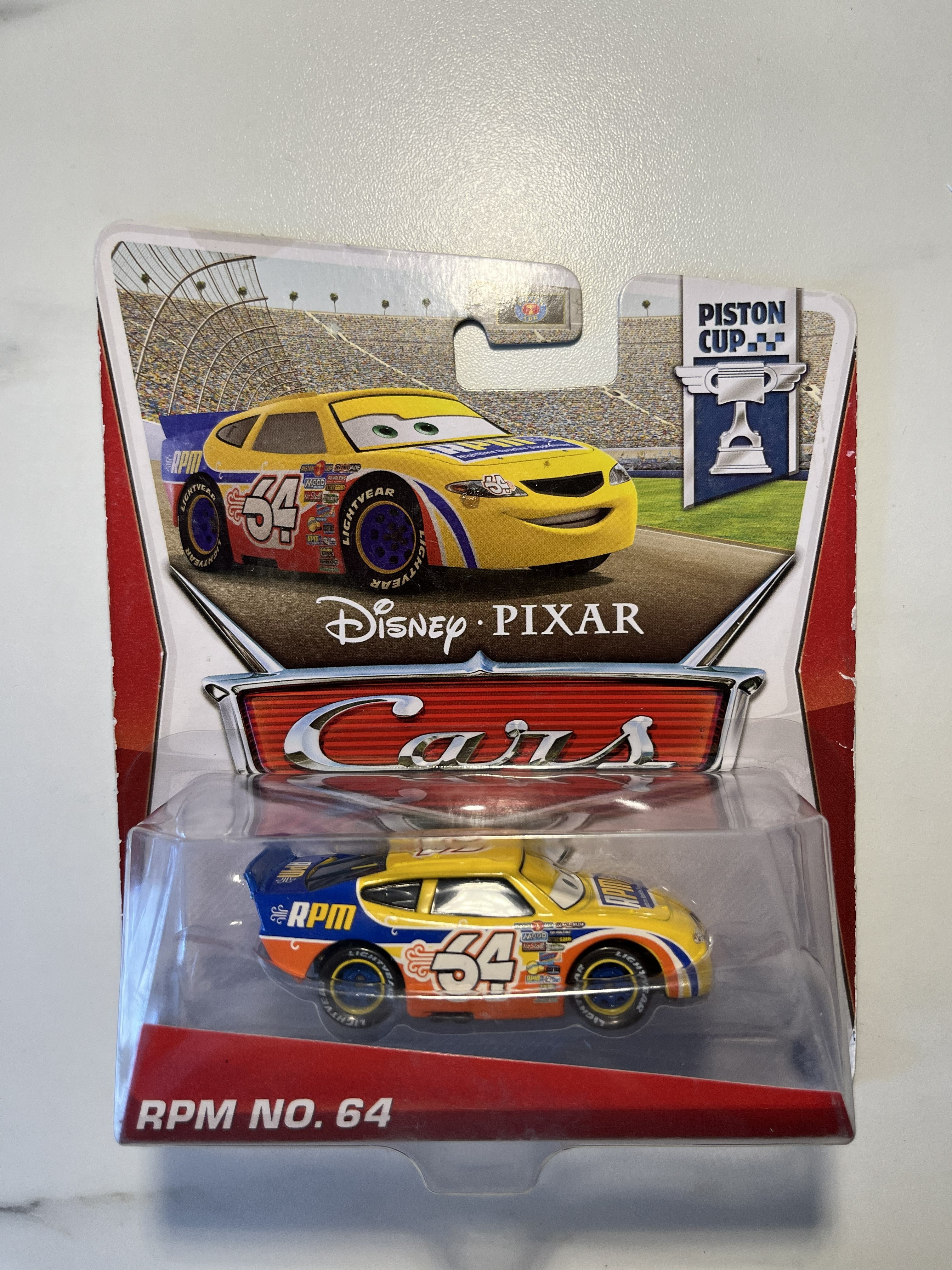 🚗 Disney Pixar Cars – RPM No. 64 – Piston Cup Series – Neuf sous blister